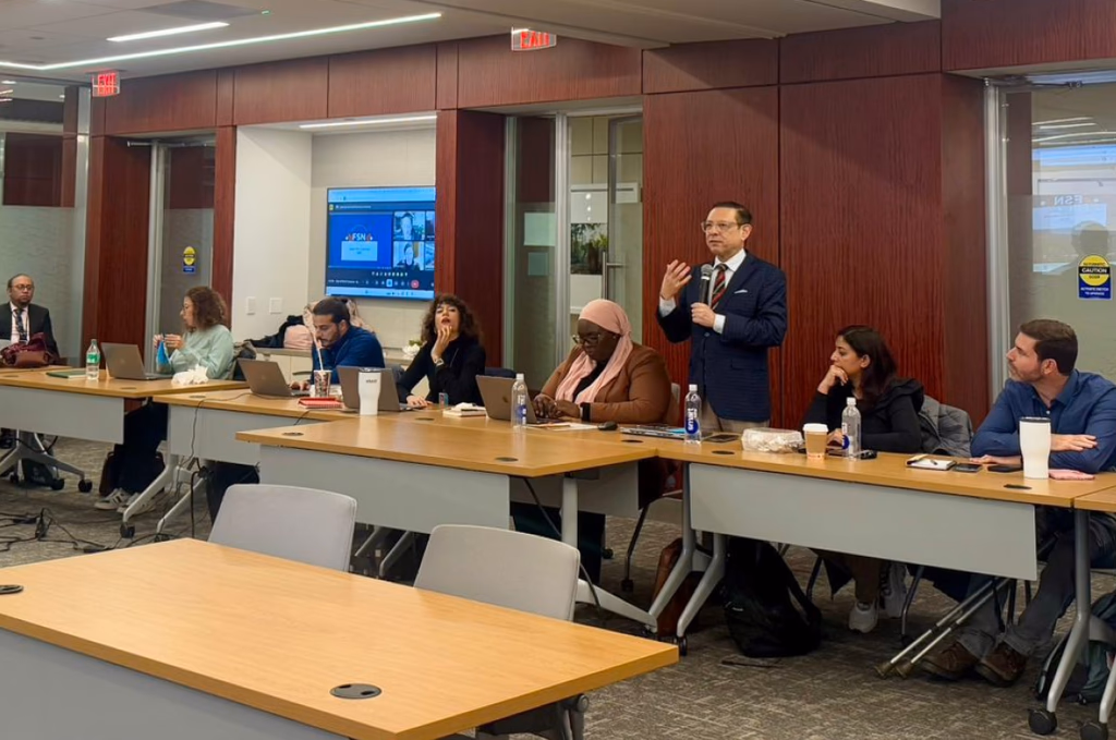 Gerardo Tablas leading a session with a seated executive group